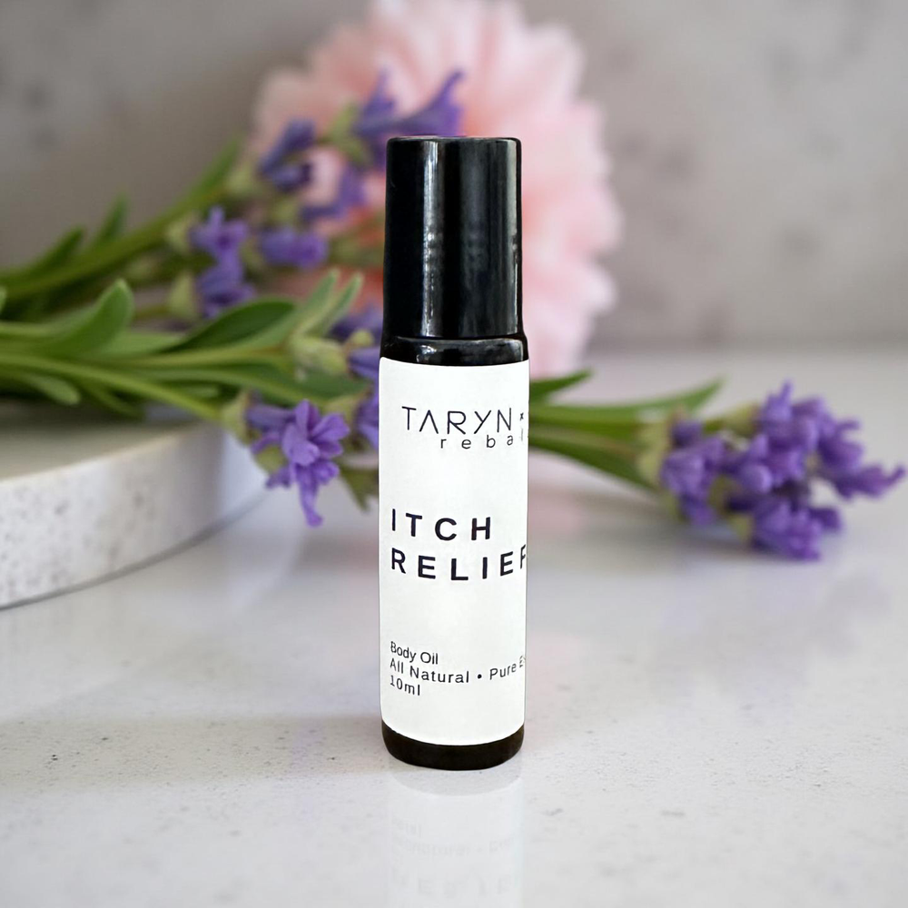 Two bottles of Taryn & Philip Itch Relief Body Oil with daisies in the background.