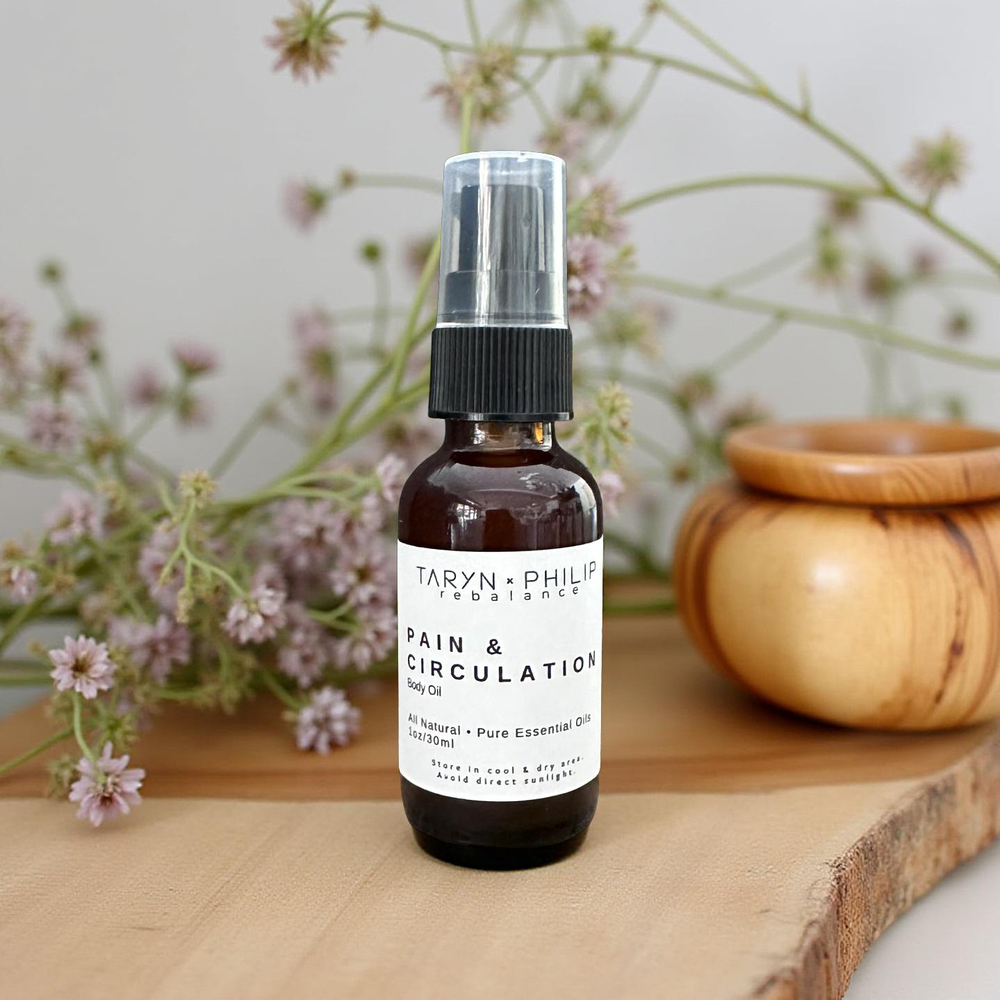 Two Taryn x Philip products on a wooden board with flowers in the background